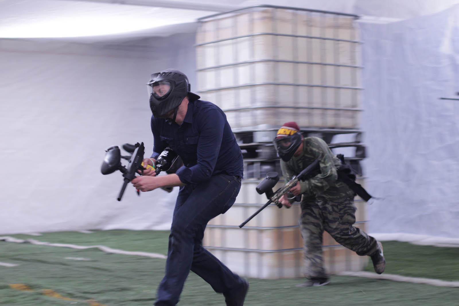 Year Round Indoor Paintball Field Apc Colorado Springs Two Paintball Players Running On The Scenario Field With Their Guns Ready During Play