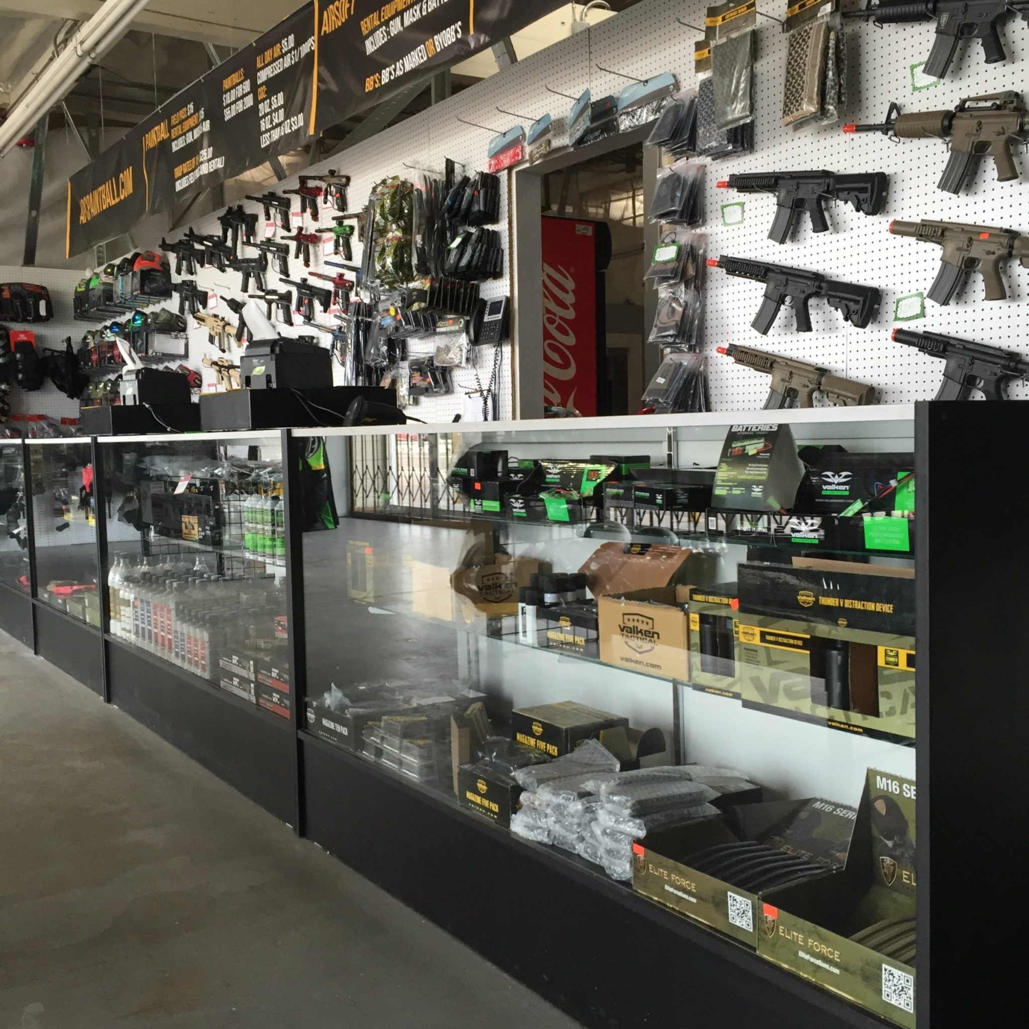 Wall of airsoft and paintball guns at the Phoenix Arizona pro shop.